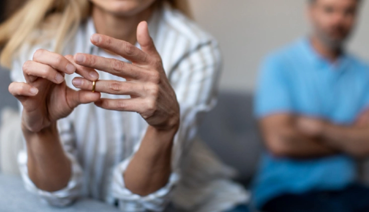 Woman removing her wedding ring while considering separation or divorce with legal guidance in Ohio